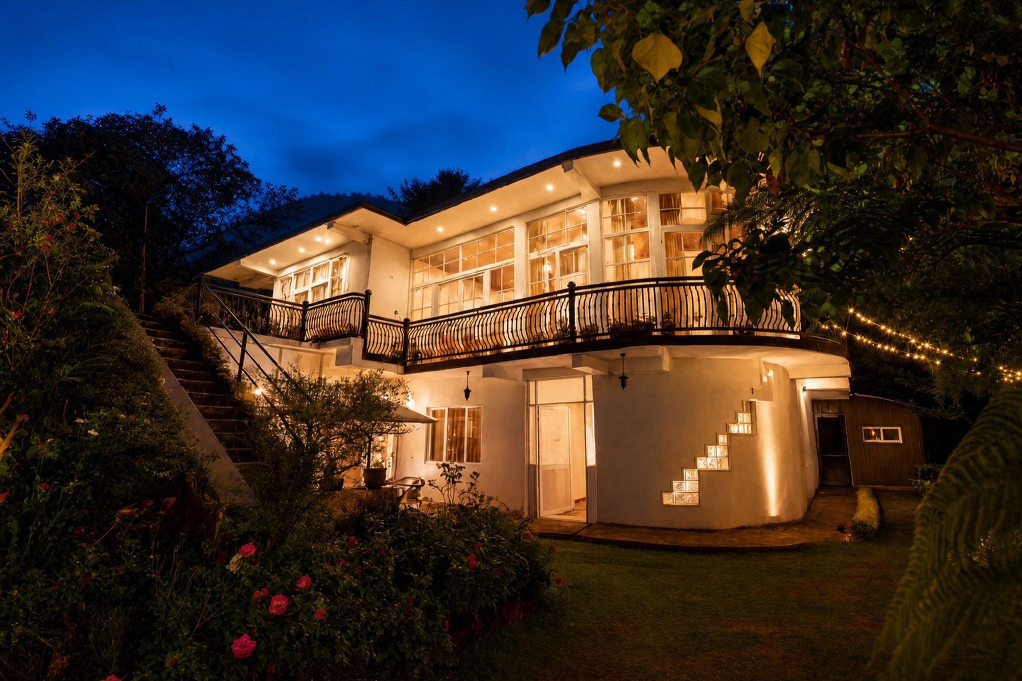 The Ceylon Lodge glowing with warm light at blue hour